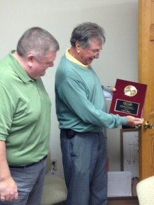 T. P. Tunstall presents Chris Shea with a 20 year plaque. 